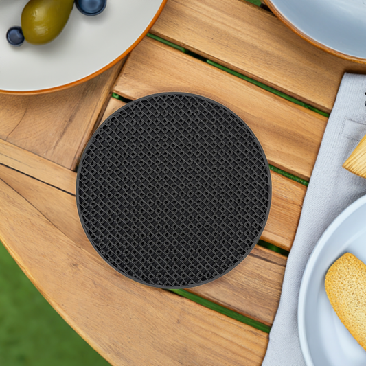 AI generated image of a black crosshatch pattern inflll coaster on a light wood table surrounded by plates of food