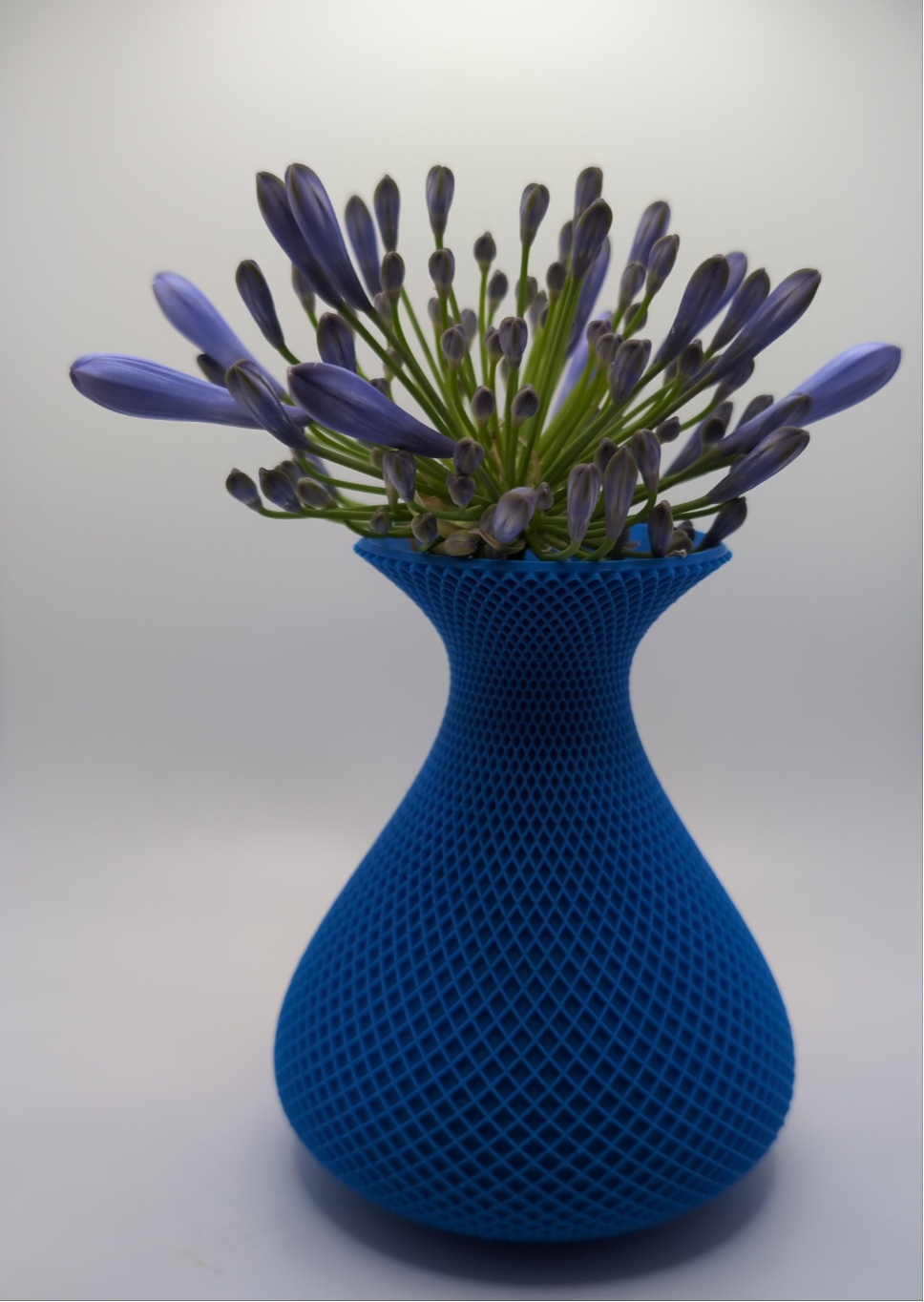 blue crosshatch vase with purple flower