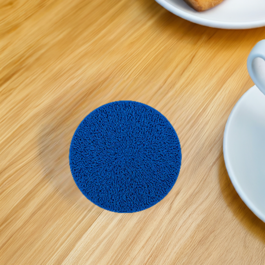 AI generated image of a blue lightning pattern infill coaster on a light wood surface next to a mug and a plate