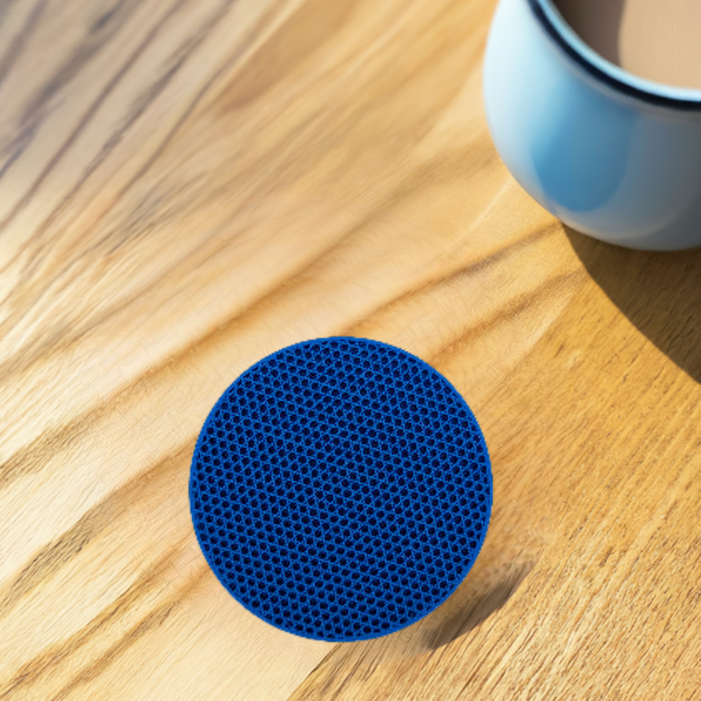 AI generated image of a blue tri-hexagon infill coaster on a light wood surface next to a coffee cup