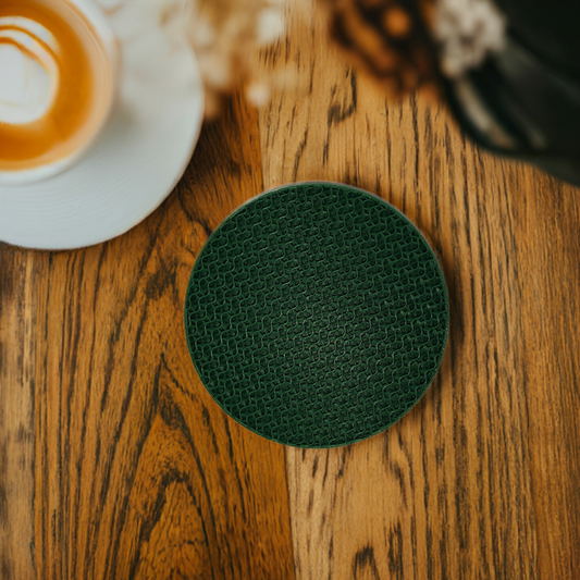 AI generated image of a green gyroid pattern infill coaster on a light wood surface next to a coffee cup