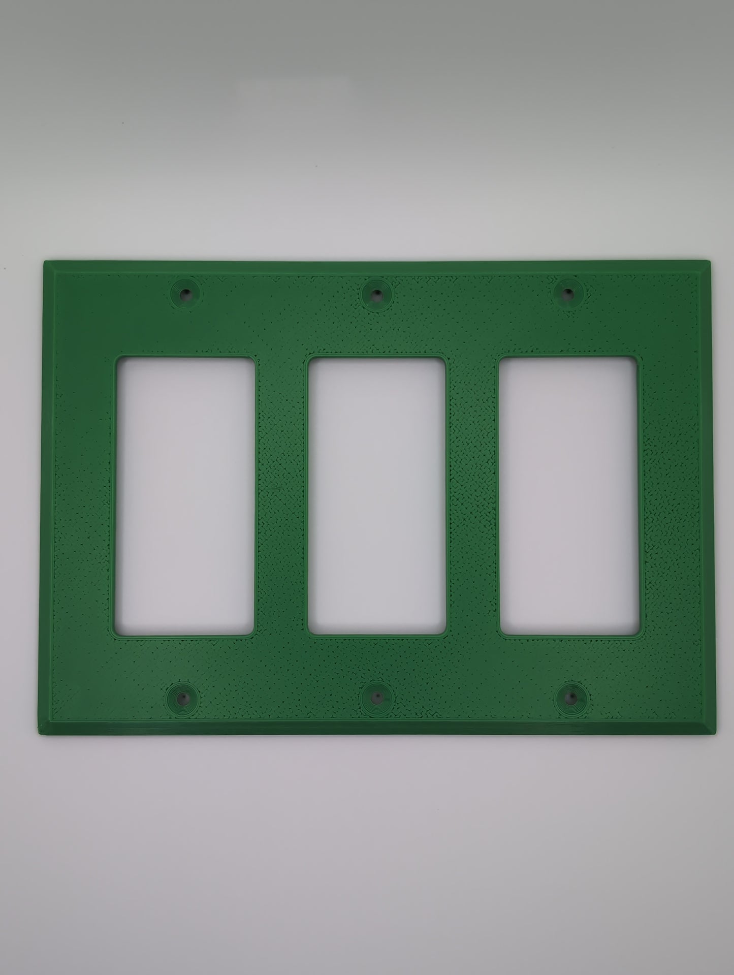 green triple switch cover with maze pattern