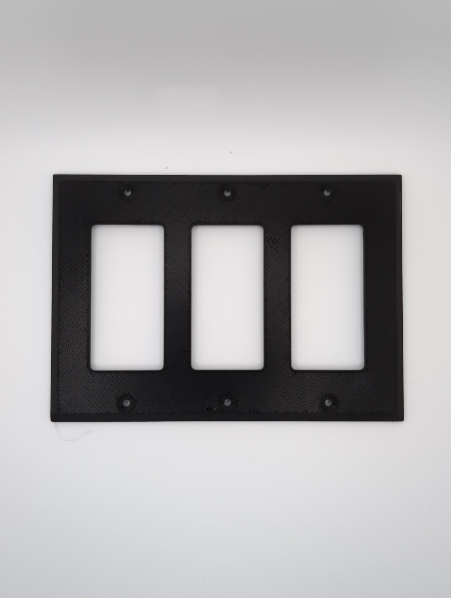 black triple switch plate with maze pattern