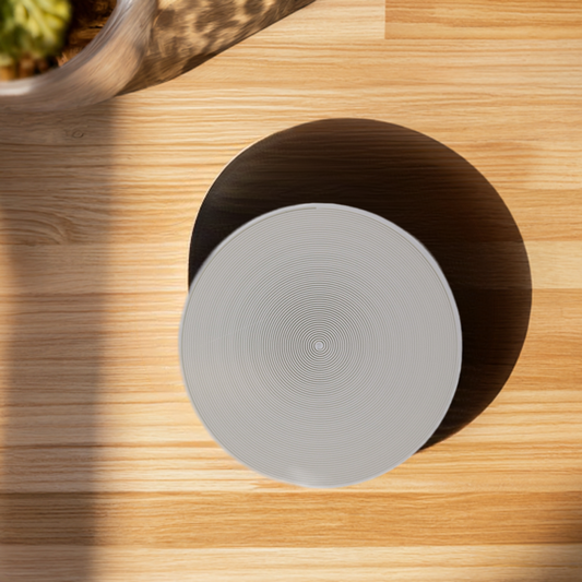 AI generated image of a white arch chords pattern infill coaster on a light wood surface