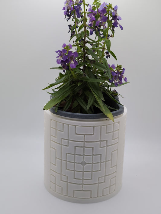 white square pattern planter with purple flowers