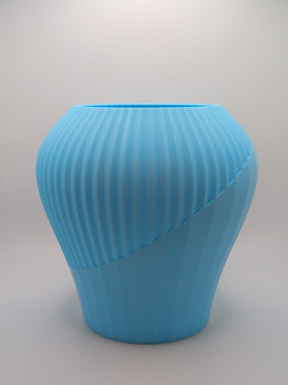 Blue textured vase on a light gray background
