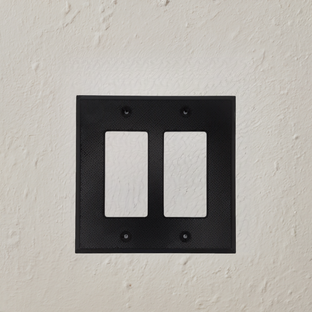 AI generated image of a black double light switch cover on a textured wall