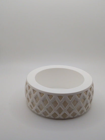 White ceramic planter with lattice design on a light gray background