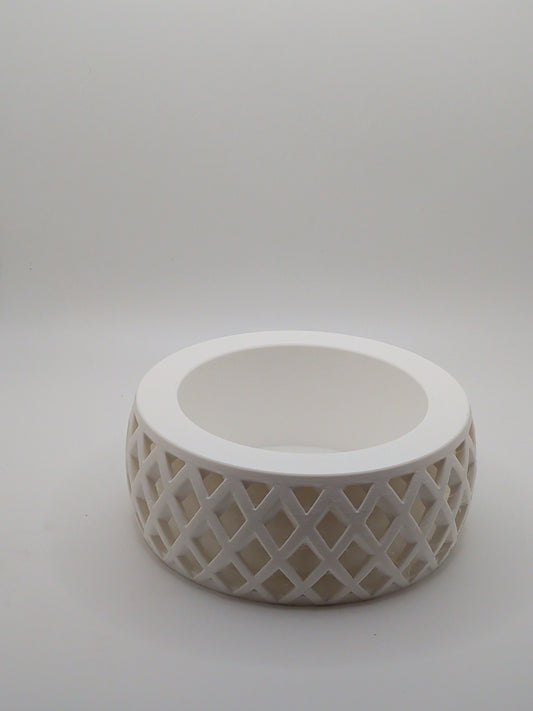 White ceramic planter with lattice design on a light gray background
