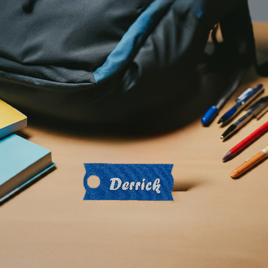 AI generated image of a large blue and white customizable name plate in front of a backpack and school supplies