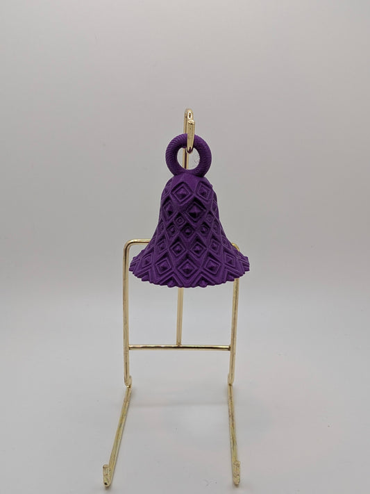 Purple textured bell-shaped object on a gold stand against a gray background