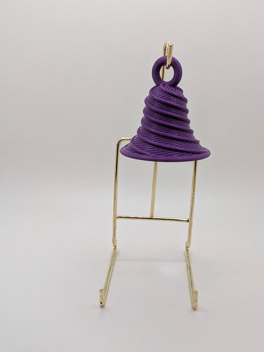 Purple spiral object on a gold stand against a white background