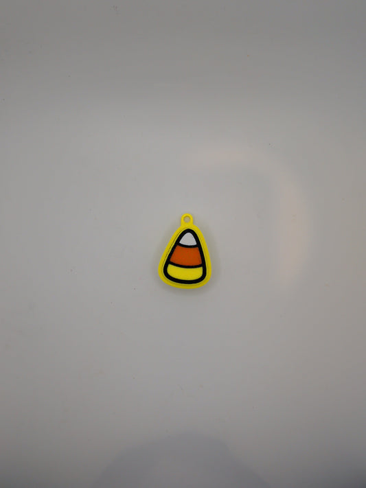 A small candy corn-shaped fidget toy with yellow, orange, white, and black stripes, shown on a plain light gray background.