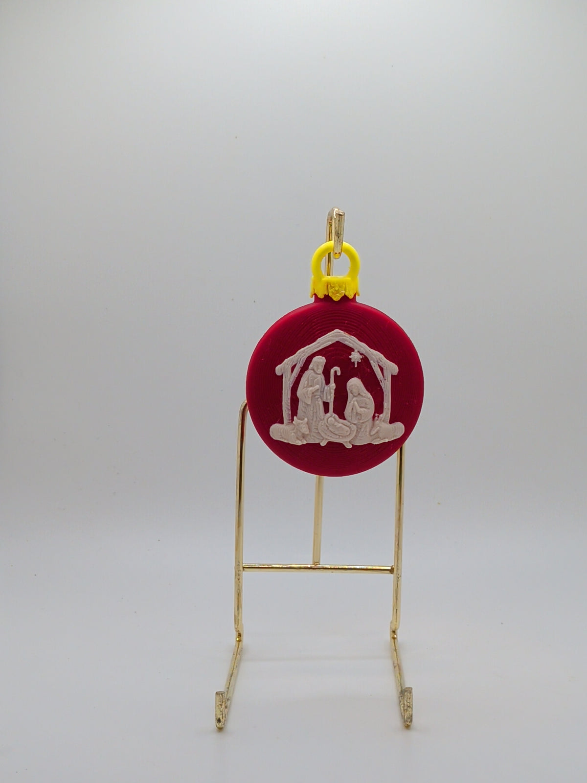 Red Christmas ornament with nativity