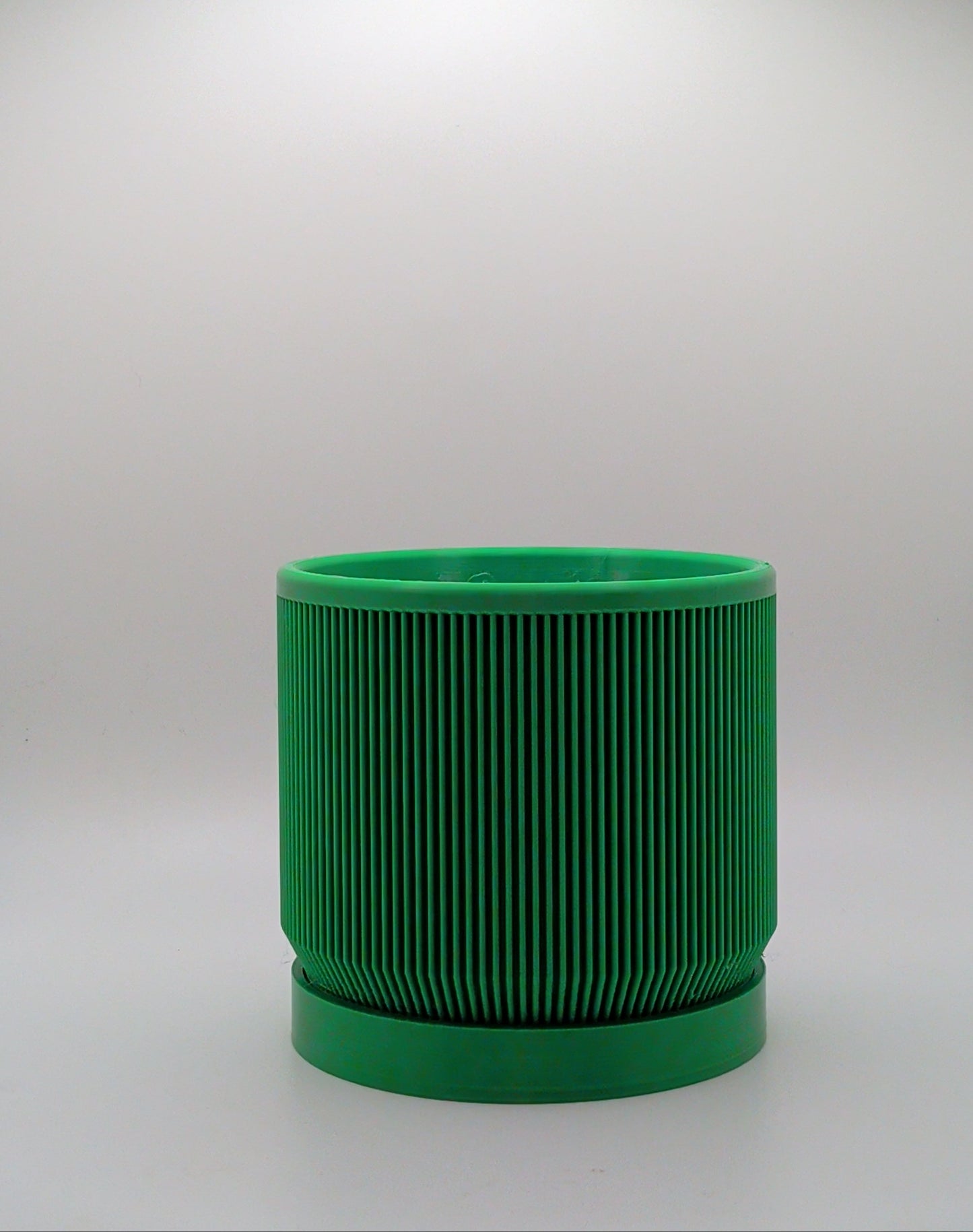 Green cylindrical object on a white background