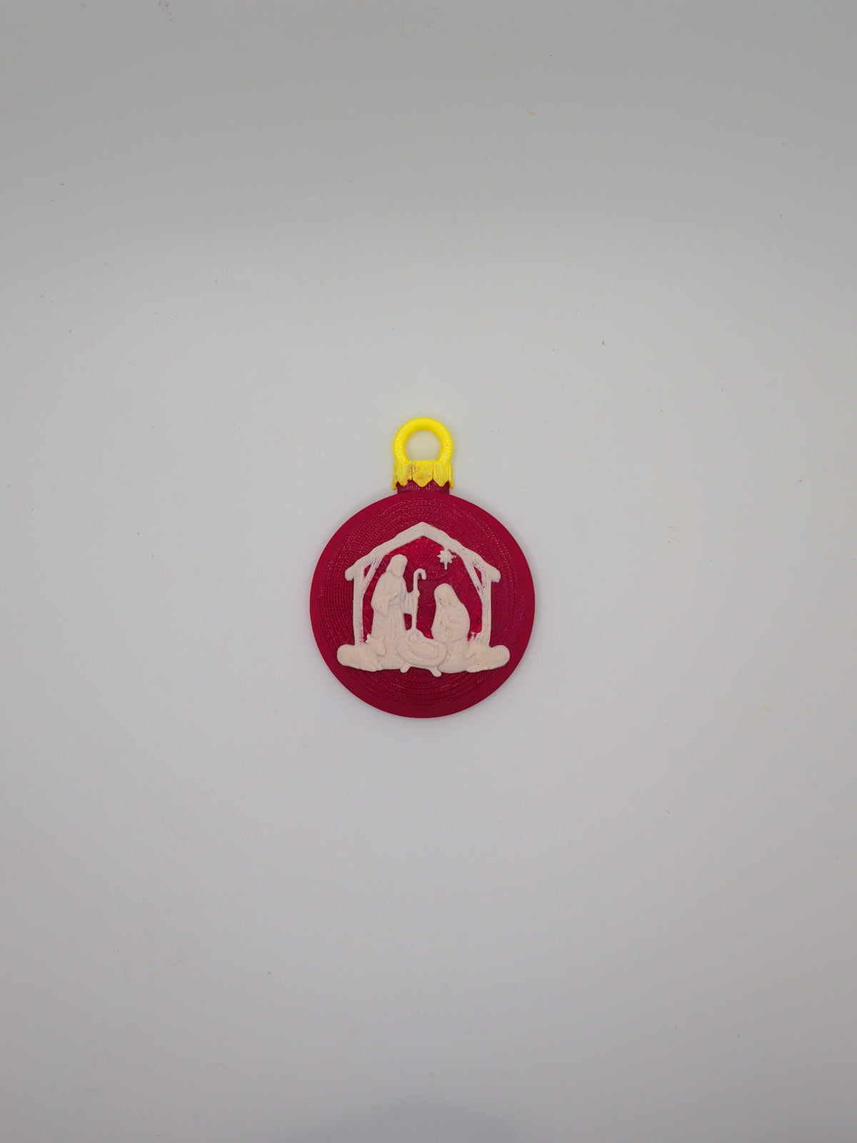 Red Christmas ornament with nativity