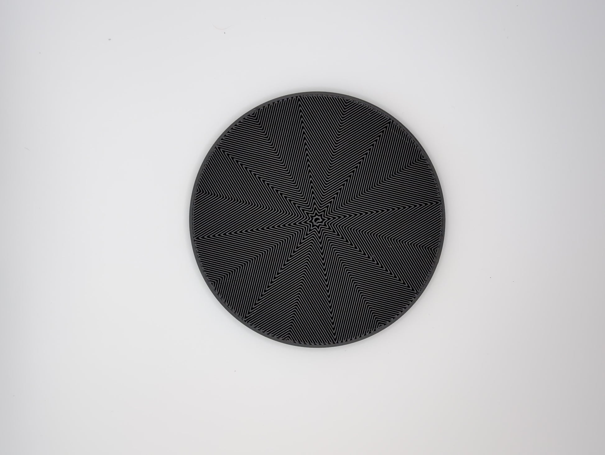 3d printed black star spiral infill coaster
