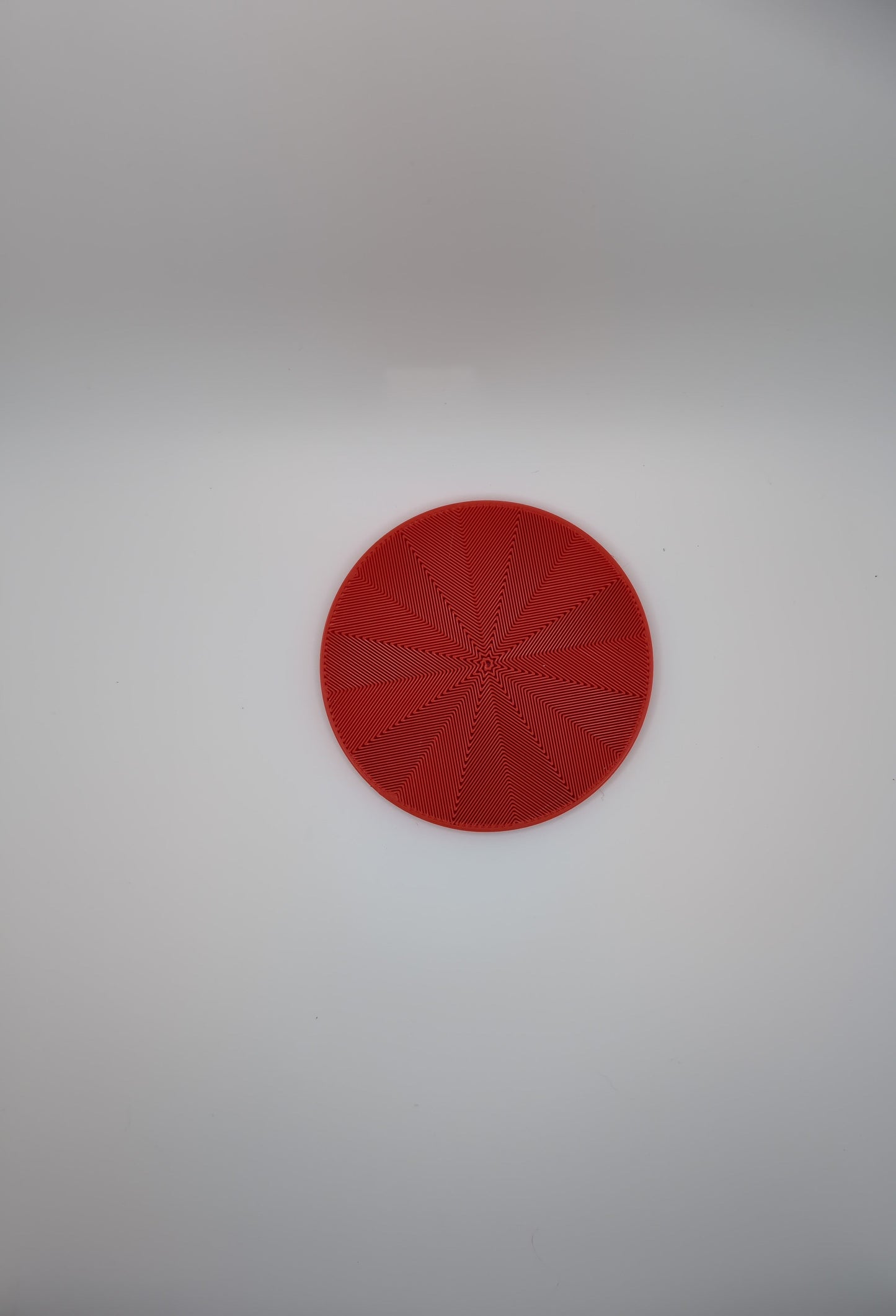 3d printed red star spiral infill coaster
