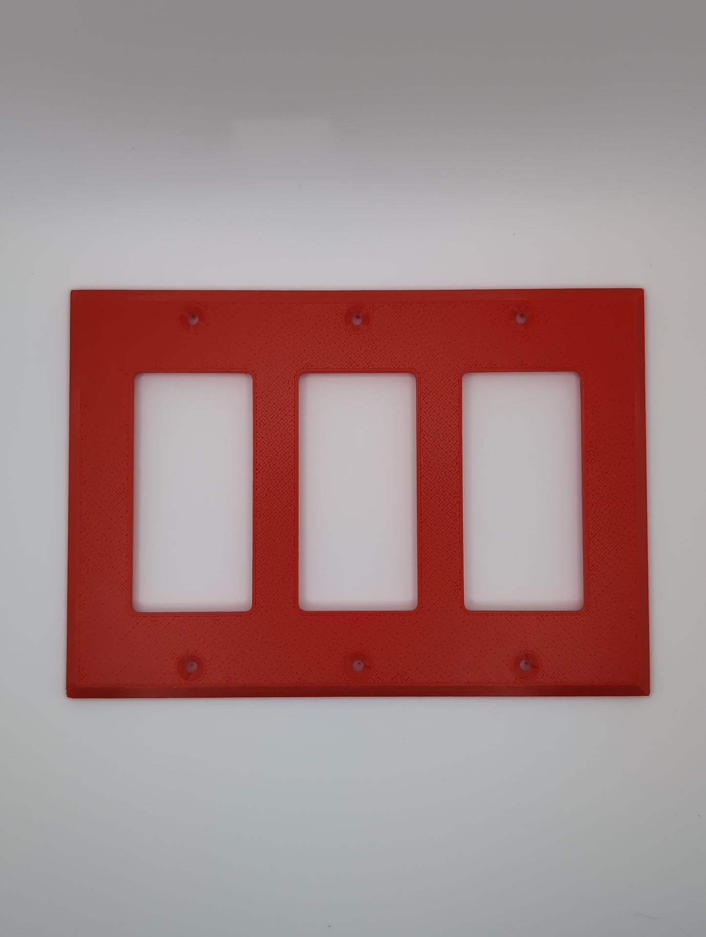 red triple light switch cover with maze pattern