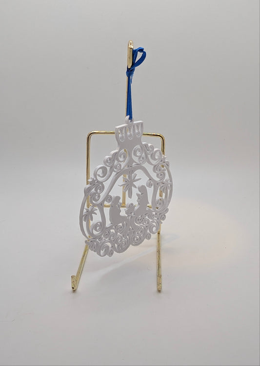 white flat manger ornament on a stand against a white background